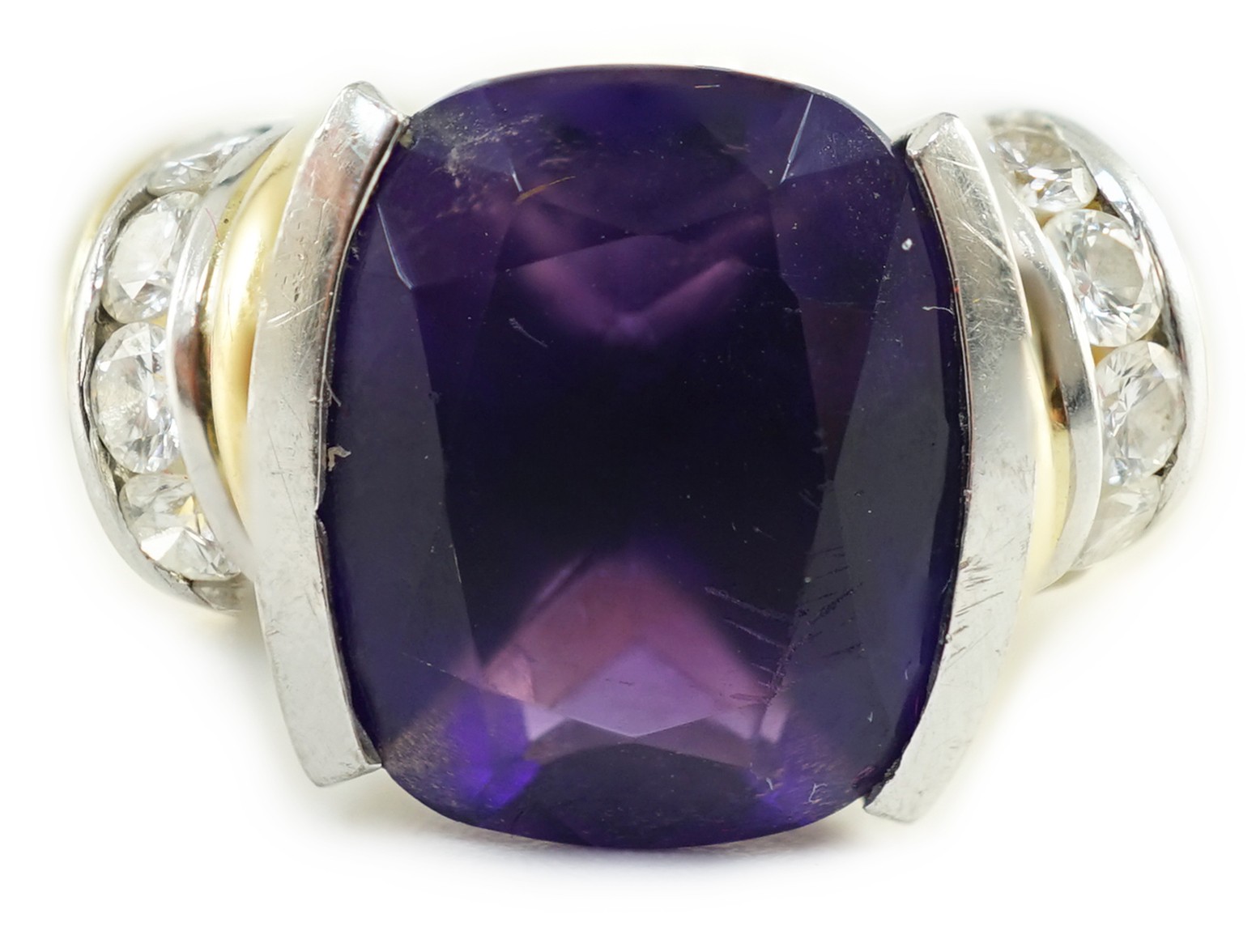 A modern 18ct gold and cushion cut amethyst set dress ring, with ten stone round cut diamond set shoulders